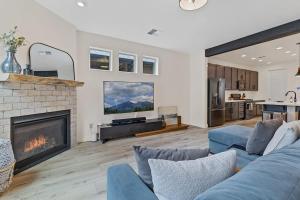 a living room with a blue couch and a fireplace at Flagstaff Home Near NAU in Flagstaff +27 photos
