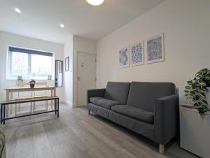 a living room with a couch and a table at Modern Apartment Near Manchester City Centre in Manchester +5 photos