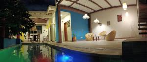 a swimming pool in a room with a house at Heliconia in Cali