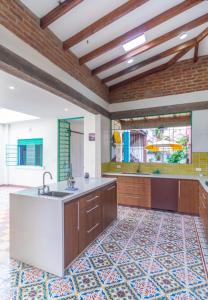 a large kitchen with a sink and a counter at Heliconia in Cali