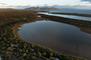 an aerial view of two rivers with mountains in the background at Numie Wattle Cocoon with Hot Tub Waterfront in Coles Bay