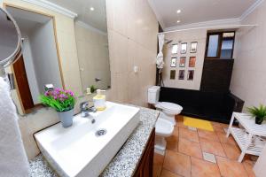 a bathroom with a sink and a toilet at Live Oporto Rooms in Porto