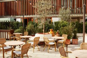 an outdoor seating area with tables and chairs at The Hoxton, Florence in Florence