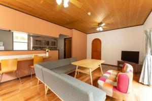a living room with a couch and a table at Green Oasis Cottage B in Hakone