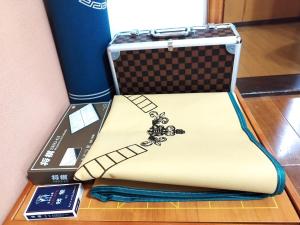 a suitcase sitting on a table with a remote control at Green Oasis Cottage B in Hakone +46 photos