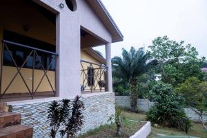 a house with a window on the side of it at Mi Casa, Your Cozy Stay in Koforidua