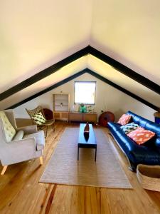 a living room with a couch and a table at Villa Ahava in Pacific Harbour