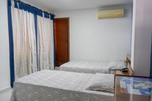 Postel nebo postele na pokoji v ubytování Hotel Veleros Cartagena