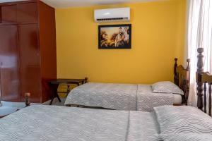 Postel nebo postele na pokoji v ubytování Hotel Veleros Cartagena