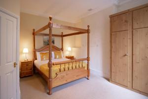 a bedroom with a wooden canopy bed in a room at New Inns in Alstonfield +47 photos
