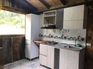 a kitchen with a sink and a stove at Hotel Monteverde Sutatausa in Sutatausa