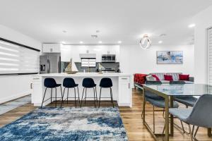 a kitchen and dining room with a table and chairs at Modern Home with large private yard - Next to downtown & beach & airport - Pet friendly in Fort Lauderdale