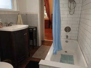 a bathroom with a tub and a sink and a shower at 2 Bedroom Unit and Big Yard 30 Minutes to NY in Ridgefield Park