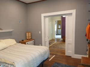 a bedroom with a bed and a door leading to a hallway at 2 Bedroom Unit and Big Yard 30 Minutes to NY in Ridgefield Park