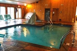 a large swimming pool in a room with chairs at Vista Ridge Retreat in Gatlinburg