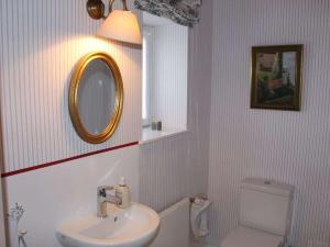 a bathroom with a sink and a mirror and a toilet at Holiday home with 4 bedrooms in Fischerhude +29 photos