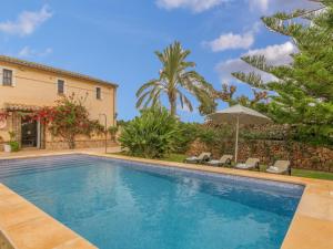 a swimming pool in front of a villa at Antonio in Mallorca with Bay Views in Búger
