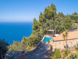 a house with a swimming pool next to the ocean at Son Galceran with Private Pool in Valldemossa