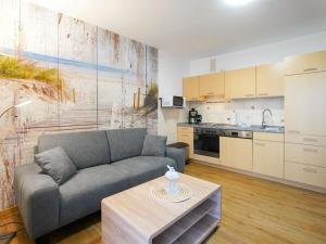 a living room with a couch and a kitchen at 1-bedroom apartment in Borkum