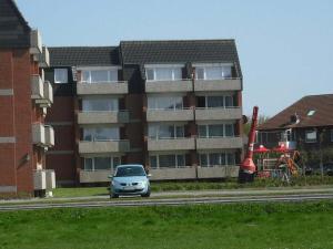 a car is parked in front of a building at 1-bedroom apartment in Borkum