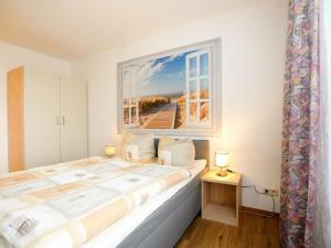 a bedroom with a large bed with a window at 1-bedroom apartment in Borkum