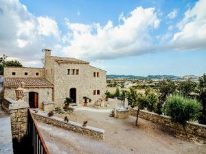 a stone house with a view of the city at Cozy Mountain-View Sa Serra in Lloret de Vistalegre