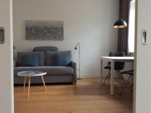 a living room with a couch and a table at Holiday apartment with 2 bedrooms in Cuxhaven