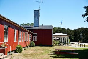 a red building with a picnic table in front of it at Rønne Vandrerhjem in Rønne