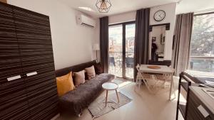 a living room with a couch and a table at Rainbow 3-213 Large Studio Delux in Sunny Beach