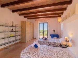 two beds in a room with a window at Palleta S'Horta near Cala Mondragó Beach in Felanitx +42 photos