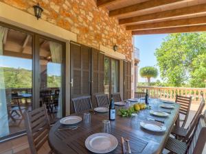 a dining room with a wooden table and chairs at Palleta S'Horta near Cala Mondragó Beach in Felanitx