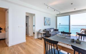a living room with a table and a couch at Cozy Apartment In Benalmadena With Wifi in Benalmádena