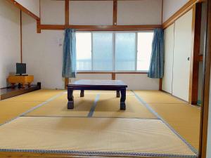 a room with a table in the middle of a room at 樸和馆1号 in Shimonoseki