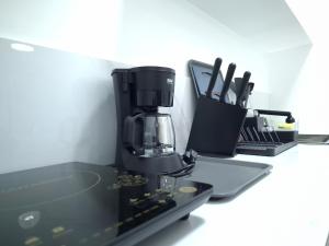 a coffee maker sitting on a counter next to a laptop at Boracay Luxury Apartments in Boracay