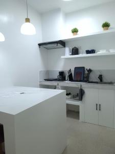 a kitchen with white cabinets and a white counter top at Boracay Luxury Apartments in Boracay