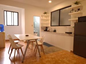 a kitchen and dining room with a table and chairs at Boracay Luxury Apartments in Boracay