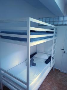 a white bunk bed with a ladder in a room at Boracay Luxury Apartments in Boracay