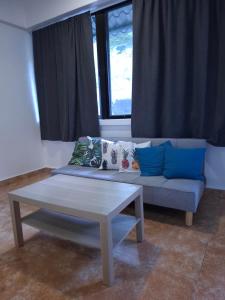 a living room with a couch and a table at Boracay Luxury Apartments in Boracay