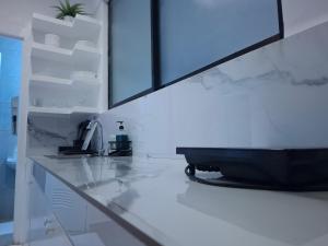 a kitchen with a counter with a tv on it at Boracay Luxury Apartments in Boracay