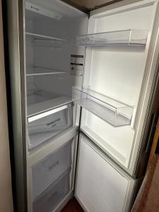 an empty refrigerator with its door open and its shelves at Acogedora y renovada casa en el corazón de San Pedro de Atacama in San Pedro de Atacama