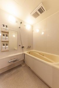 a white bathroom with a tub and a shower at Premier suite Shinjuku okubo Tokyo 3F in Tokyo +33 photos