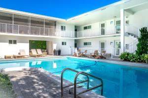 a swimming pool in front of a building at Beachside 2BR 2BA - Pool & Balcony - Steps to Boca Beach in Boca Raton