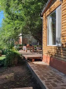a log cabin with a picnic table on a patio at Ananda Ganesha in Villa Ventana +12 photos