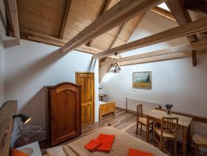 a bedroom with a table and a dining room at Penzion Krakovice in Kaplice