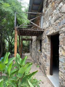 an outside view of a stone building at Cabañas Cuyum in El Volcán +3 photos