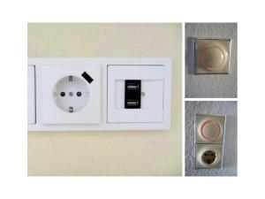 una toma de corriente blanca en una pared en my, your, our holiday apartment, en Cuxhaven