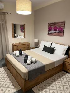 a bedroom with a large bed with towels on it at Nektaria philoxenia place in Athens