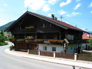 a black and white house with flowers on the balcony at Haus Seiwald in Niederau