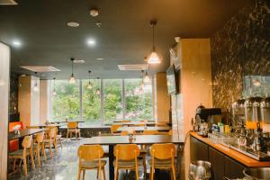 un ristorante con tavoli e sedie e un bar di Hermes Hotel Nha Trang a Nha Trang
