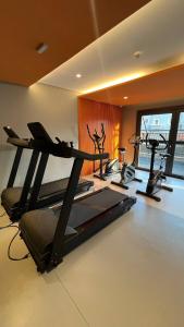 a gym with three treadying machines in a room at TU 1501 Deslumbrante Apartamento Em Frente Ao Metrô Tucuruvi - Avenida Guapira 79 - Raizes Tucuruvi Figueira in Sao Paulo +37 photos
